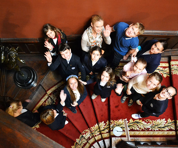 Photo. Leader and a group of students at the grand staircase